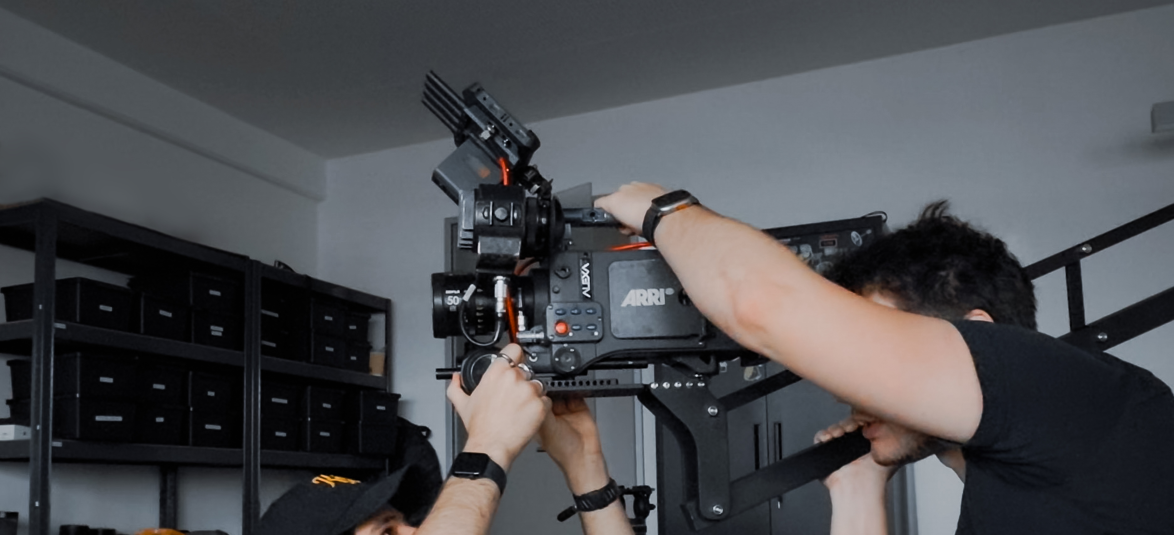 Two of the Aldea Labs team assembling a custom camera rig in the gear room